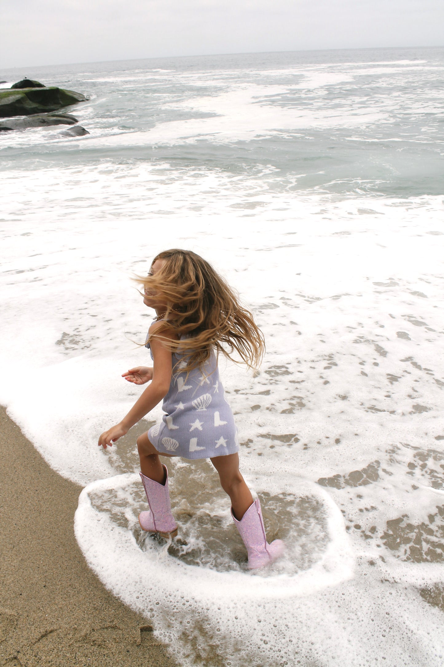 Coastal cowgirl lavender knit dress on the beach for toddler girls mermaid core beach dress