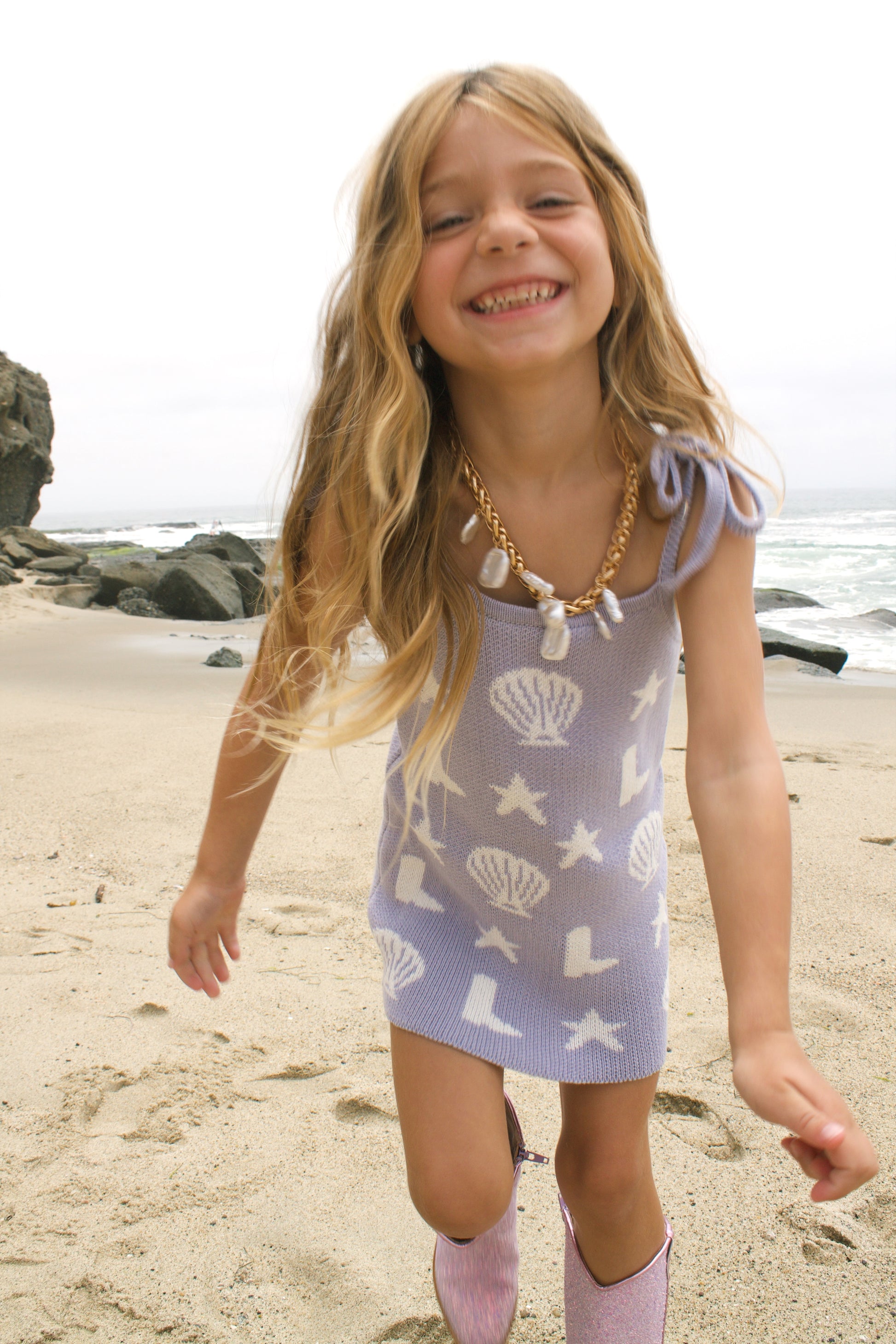 Coastal cowgirl lavender knit dress on the beach for toddler girls 