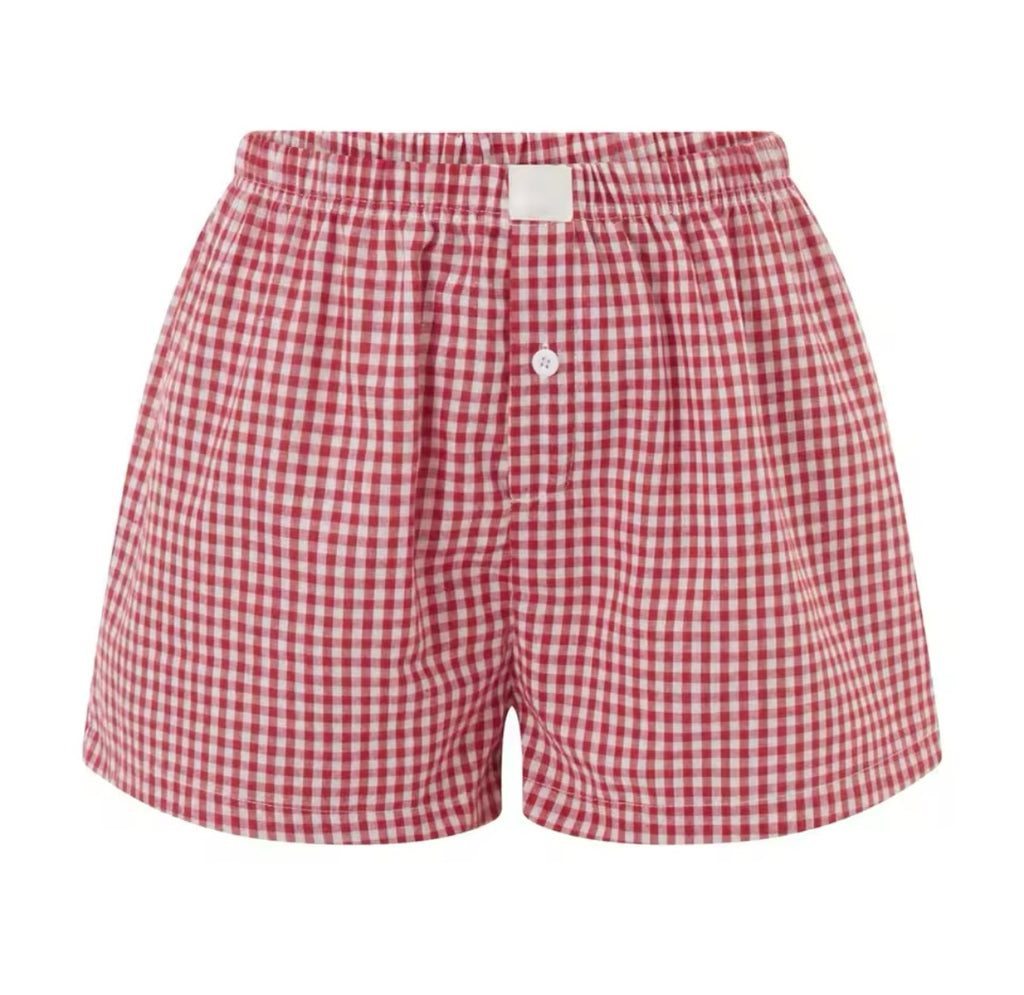 Flat lay of red gingham mommy and me matching shorts – toddler and adult sizing
