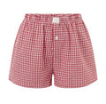Flat lay of red gingham mommy and me matching shorts – toddler and adult sizing