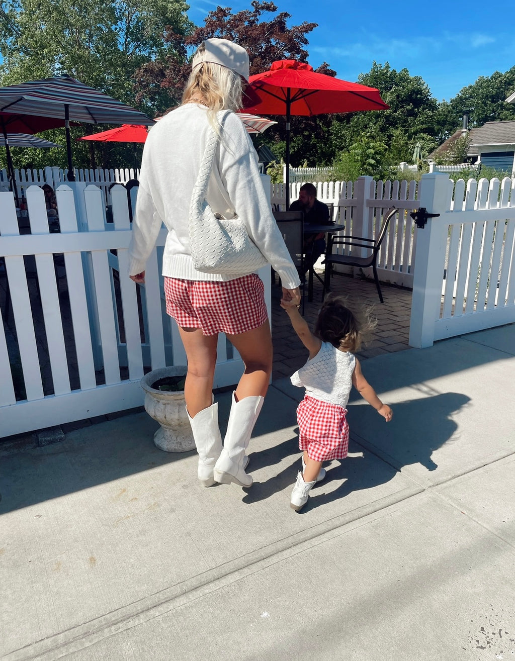 Mom and daughter wearing matching red gingham shorts walking outside – patriotic summer outfit