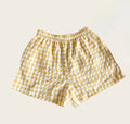 Yellow checkered shorts on a beige background