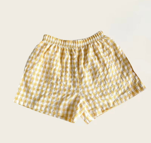 Yellow checkered shorts on a beige background